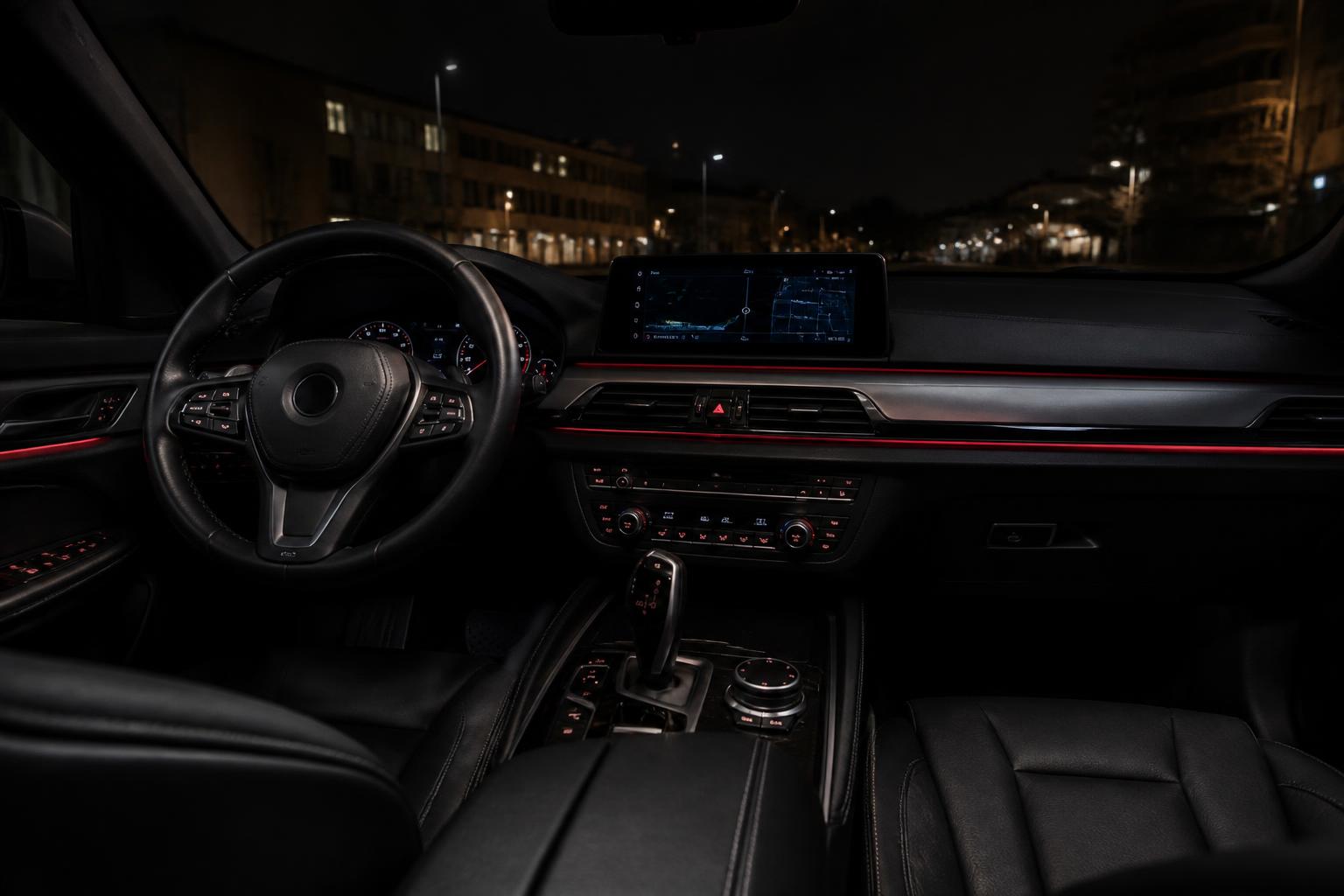 Modern car interior with steering wheel, dashboard and leather seats